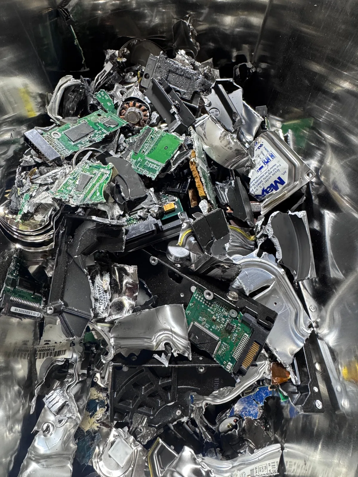 Shredded hard drive fragments after physical data destruction