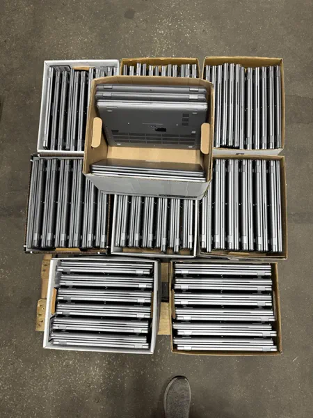 Rows of Lenovo and HP Chromebooks boxed up from a school district