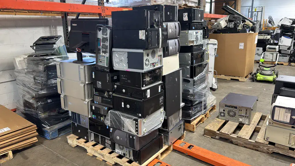 Desktop computer towers stacked on pallets