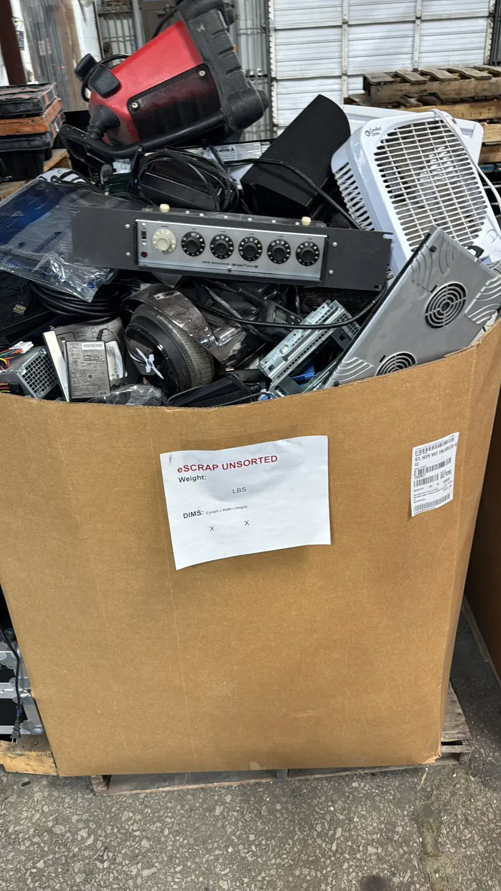 A gaylord box of unsorted electronic scrap headed for recycling