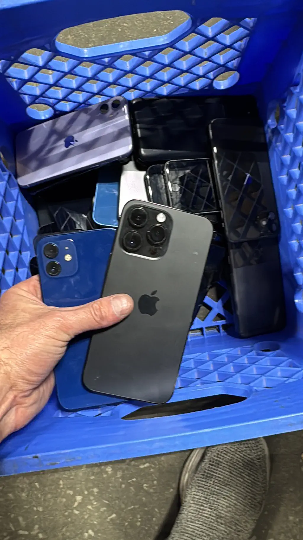 A crate of used smartphones